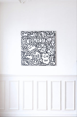 Œuvre d’art contemporaine intitulée ‘CHAS en vacances’ par Chanoir (2025). Acrylique sur toile, noir et blanc, représentant personnages félins et souriants, typiques du style street art de l’artiste, mise en scène de décoration d'intérieur.