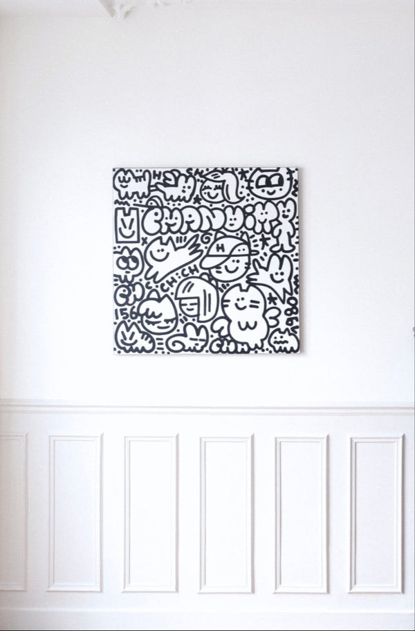 Œuvre d’art contemporaine intitulée ‘CHAS en vacances’ par Chanoir (2025). Acrylique sur toile, noir et blanc, représentant personnages félins et souriants, typiques du style street art de l’artiste, mise en scène de décoration d'intérieur.