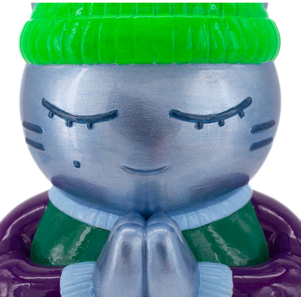 Close-up de la sculpture de l'artiste street art CHANOIR "Tempérance" en résine, chat qui médite, bonnet vert fluo.