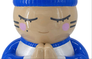 Détail de la tête de la sculpture CHANOIR, coiffée d’un bonnet bleu vif, vêtue d’un maillot blanc nacré avec manches bleu vif et orné d’un motif de chat à rayures colorées sur le dos. Pièce unique peinte à la main, fusion de street art et sculpture contemporaine.